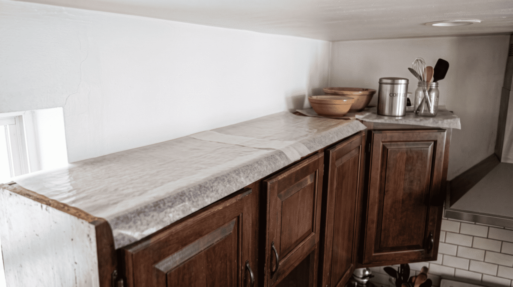 Above Kitchen Cabinet Decor Ideas for a Stylish Kitchen Wax paper lining the top of kitchen cabinets to catch grease and dust